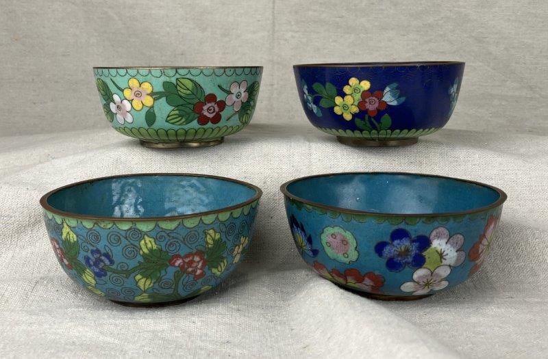 Set of Four Chinese Cloisonné Bowls: Collection of four Chinese cloisonné bowls, each featuring intricate enameled surfaces with vibrant floral designs in rich, multi colored tones. Each measure approximately 2" H x 4 5/8" in diamet