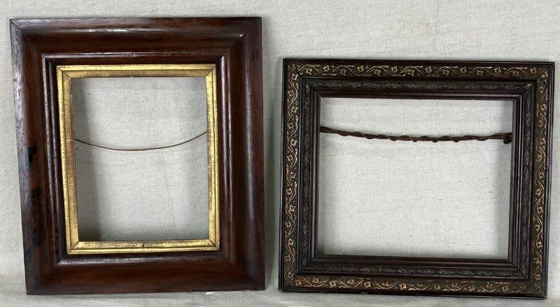 Pair of Early Carved Wood Frames: Fine examples of early craftsmanship, including one mahogany frame with a gilded liner and another delicately carved with gilded ivy motifs set against a rich dark wood patina. The largest frame measu