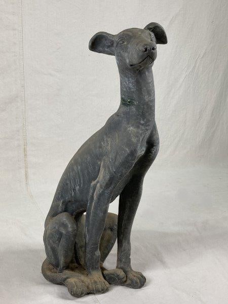 Concrete Whippet Sculpture: Handsome and well-proportioned sculpture depicting a seated whippet with finely modeled features and smooth surface detail. Measures approximately 35'' H x 14'' W x 14'' D. Condition: Head has been re
