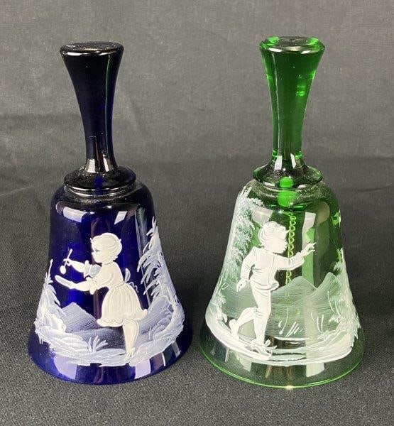 Mary Gregory Bohemian Motif Glass Bell Pair: Charming vintage glass bell in the Mary Gregory style, featuring a child delicately painted in white on a green glass surface. Measures approximately 6" H x 3" in diameter. Good condition.