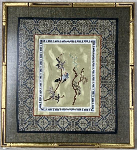 Asian Silk Embroidery: Charming silk embroidery featuring a delicately stitched bird motif framed by an intricate border. Presented in a complementary gold bamboo-style frame that enhances the decorative appeal. Frame measu