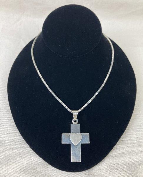 Sterling Silver Cross Necklace: Elegant sterling silver necklace featuring a raised heart motif cross suspended from an 18-inch Italian box chain with a lobster claw clasp. Both pendant and chain stamped 925, with chain additionally