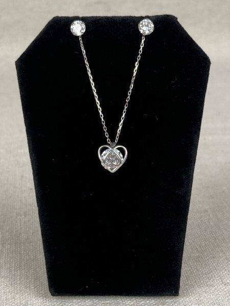 Sterling Silver Necklace and Earrings: Elegant sterling silver jewelry featuring a heart-shaped pendant necklace with a mounted cubic zirconia suspended at center, on a 17 3/4'' chain with lobster claw clasp and hallmarked charm, stamped 9