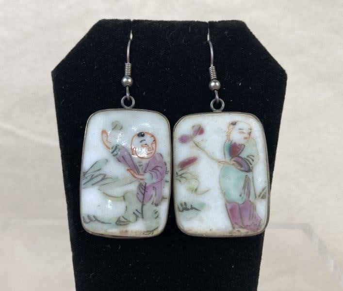 Chinese Porcelain and Sterling Silver Earrings: Charming hand-painted porcelain earrings depicting figures in traditional Chinese dress, framed in sterling silver square settings. Dangle form, stamped S to denote sterling content. Each earring meas