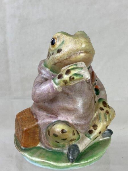 Beatrix Potter "Mr. Jeremy Fisher" Porcelain Figurine: Charming Beatrix Potter porcelain figurine by Beswick, England, depicting Mr. Jeremy Fisher seated upon a lily pad. A whimsical and finely detailed interpretation of the beloved character from Potter'