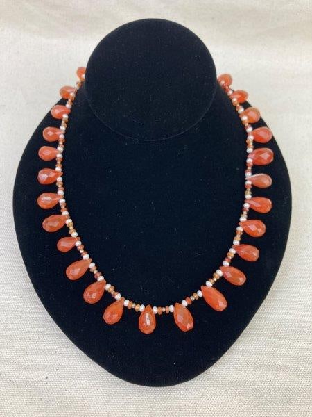 Cut Carnelian and Bead Necklace: Beautiful necklace featuring polished carnelian beads with faceted cuts that reflect light and highlight the stone's rich red-orange tones. Accented with faux pearls, coordinating beads, and silver-to