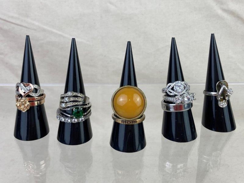 Collection of Silver-Tone Rings: Assorted collection of silver-tone rings featuring decorative designs in various sizes. Some exhibit minor tarnishing and light wear consistent with age and use. Overall in good condition.