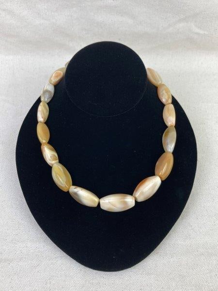 Agate Stone Beaded Necklace: Elegant necklace featuring polished oblong agate stones displaying natural banding and warm earth-toned hues. Measures approximately 17" long. One stone measures approximately 1/2" H x 1" W x 1/2"D. I