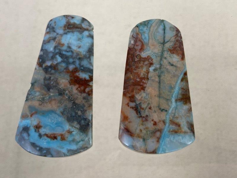 Rainforest Jasper Stone Pair: Beautiful rainforest jasper stones displaying turquoise veining interwoven with warm earthy brown and green tones. Known for their natural variation and rich polish. One stone measures approximately 2