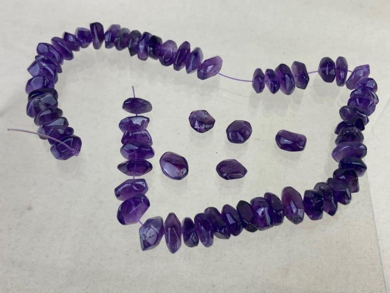 Amethyst Beads: Collection of polished amethyst beads showcasing rich purple tones and translucent natural variation. Ideal for jewelry making or craft projects. One bead measures approximately 1/4" H x 1/8" W x 1/8"