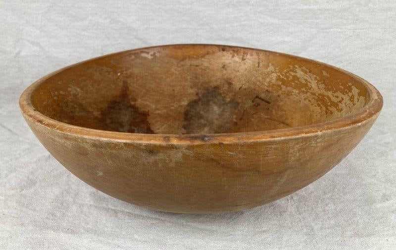 Turned Wooden Dough Bowl: Beautifully turned wooden dough bowl exhibiting a rich, well-aged patina and smooth surface from years of use. Classic utilitarian form with natural grain variation and warmth. Measures approximately