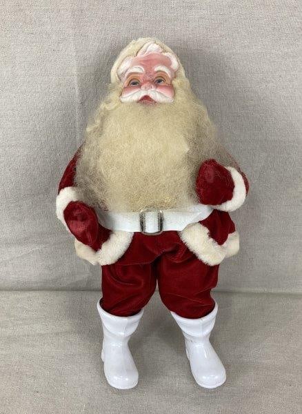 Vintage Santa Figurine: Nostalgic Santa Claus figurine dressed in a traditional red velour suit with faux fur trim, featuring expressive facial details and classic holiday charm. Measures approximately 13" H x 7 3/8" W x 6" 
