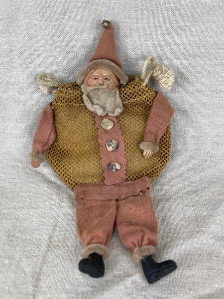 Antique Santa Mesh Candy Bag: Charming antique Santa Claus candy bag, featuring a mesh netting body designed for candy storage and formed as a Santa figure with a detailed painted face, black boots, and red fabric suit and hat. A