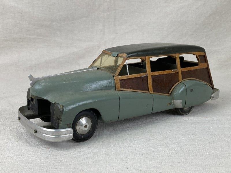 Vintage Ford Woody Station Wagon: Charming vintage toy station wagon modeled after the classic Ford "Woody", featuring detailed craftsmanship and an appealing aged patina. Measures approximately 3 7/8'' H x 4'' W x 11 3/8'' D. Good co