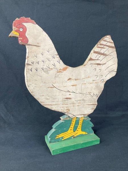 Folk Art Wood Chicken: Whimsical folk art wooden chicken mounted on a painted green base with charming hand-painted details and a warm aged patina. Measures approximately 15 7/8'' H x 14'' W x 3 1/2'' D. Good condition with
