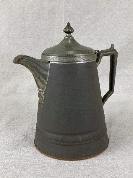 Tin Coffee Pot: Handsome tin coffee pot featuring a copper base and pewter mounts, showcasing a pleasing contrast of mixed metals. Measures approximately 10" H x 9" W x 6" D. Some wear and darkening to the metals con
