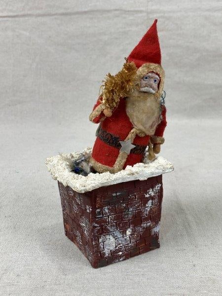 Vintage Cross Creek Collection Santa Figurine, 1967: Charming mixed-material holiday figurine featuring Santa climbing down a chimney, crafted with fabric, paper, faux greenery, and other decorative materials.Signed on base. Displays distinctive handmad