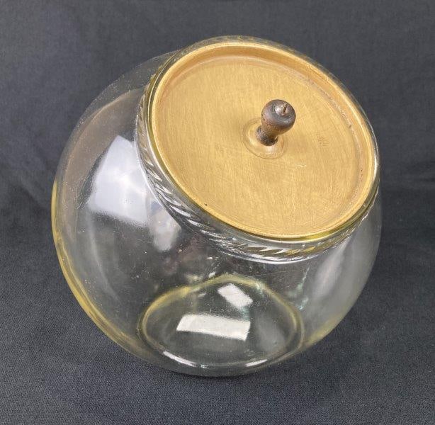 Vintage Bubble Glass Candy Jar: Charming vintage bubble glass candy jar featuring a flat base, linear patterned rim, and fitted metal lid. Exhibits an appealing aged patina and classic form. Measures approximately 7 1/2'' H x 7'' W
