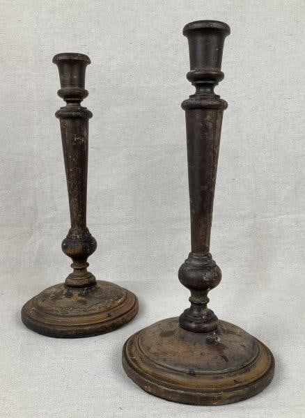 Vintage Wood Candlesticks: Classic turned wood candlesticks featuring wide round bases and a rich dark aged patina. Elegant in form with a timeless country appeal. One measures approximately 12 1/2'' H x 5 7/8'' W x 5 7/8'' D.