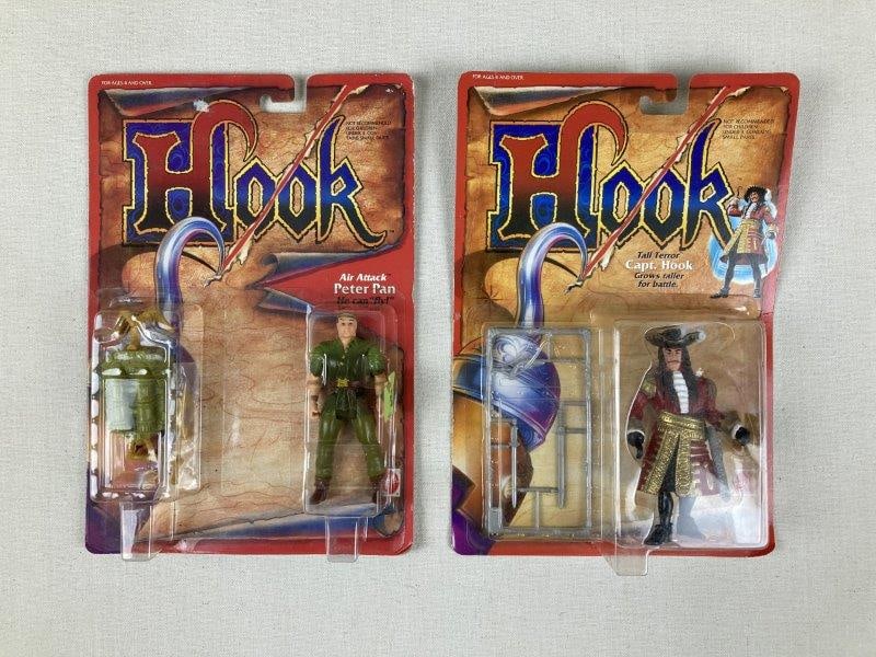 Vintage Mattel Hook Action Figures: Two 1991 Mattel action figures including Tall Terror Captain Hook with weapons and Air Attack Peter Pan, each in original packaging with accessories present. One box measures approx. 11 in. H Ã&#