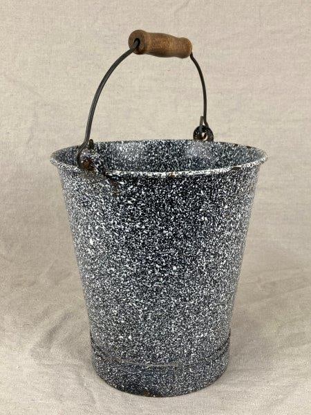 Speckled Enamelware Bucket: Charming metal bucket featuring a classic speckled enamel finish, showcasing utilitarian country style. Measures approximately 10 3/8" H x 9" in diameter. Condition: Some abrasions and wear to the ena