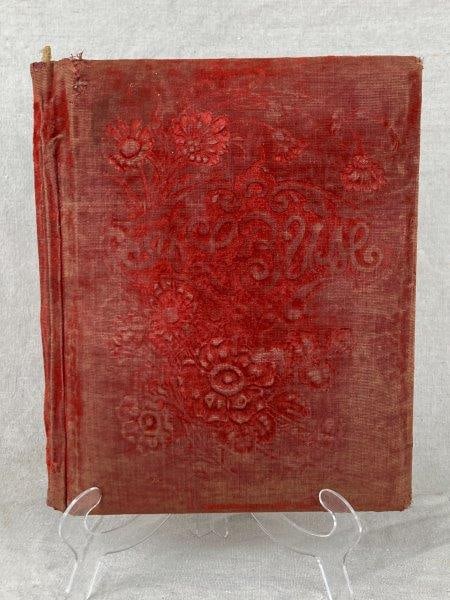 19th Century Embossed Velvet Photo Album: Velvet-bound photo album with embossed red floral motif to the cover and interior pages with multiple photographic openings. Measures approx. 11 in. H × 8 1/2 in. W × 2 in. D. Age-related we