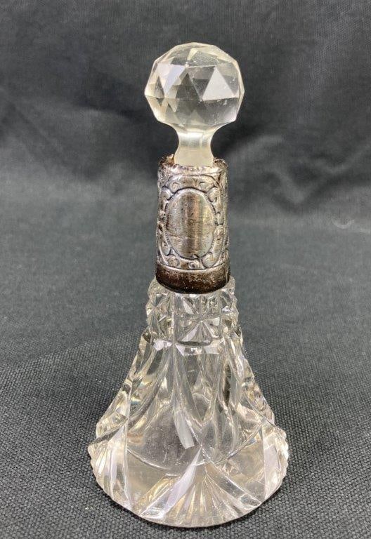 Sterling Silver and Glass Perfume Bottle: Antique sterling silver and glass perfume bottle featuring an embossed silver top marked with English hallmarks, including the lion passant denoting sterling silver; additionally tested for silver con