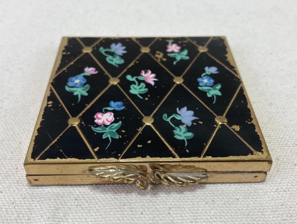 Volupte MCM Floral Enamel and Gold Tone Compact: Volupte mid-century compact featuring distinctive wing-style clasps and diamond-shaped gold tone panels centered with a colorful enamel floral motif, embodying classic MCM design. Marked with the make