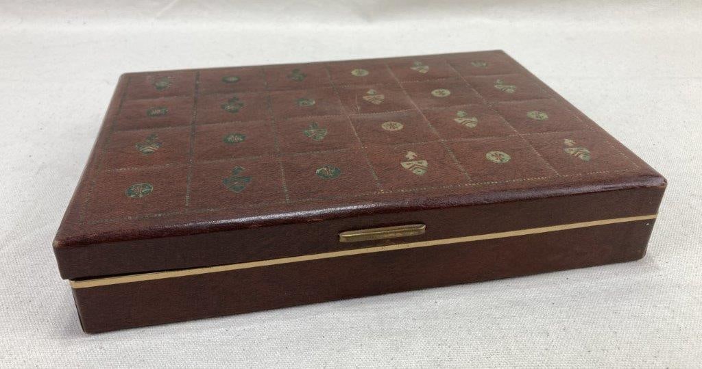 Vintage Babcock Jewelry Box: Vintage Babcock jewelry box featuring a tooled leather exterior with a refined crest and fleur-de-lis grid motif across the lid, paired with a soft velvet-lined interior designed for elegant storage.