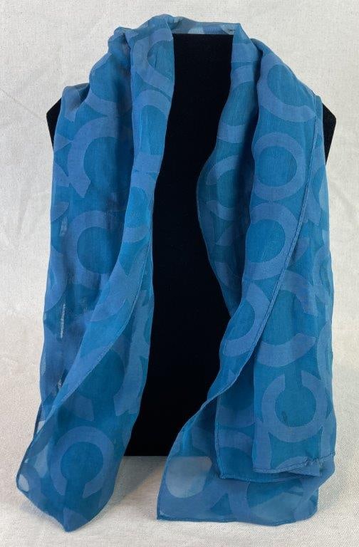 Coach Teal Logo Scarf: Coach logo scarf in rich teal tones featuring an allover signature pattern and a bedazzled Coach name accent for added sparkle. Measures approx. 62" in length. In good condition with minimal wear. **P