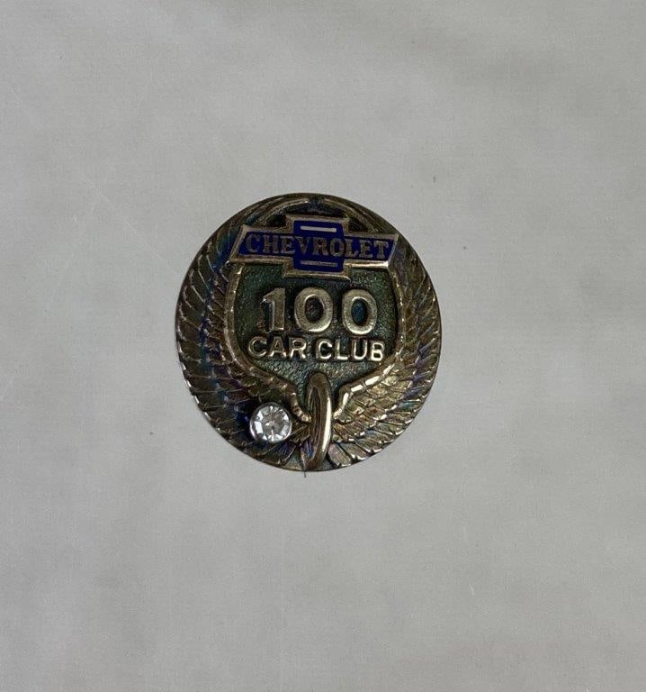 Chevrolet 100 Car Club 10Kt Brooch Pin: Chevrolet 100 Car Club brooch pin featuring the classic Chevrolet emblem with stylized wings and a central clear faceted stone that adds a touch of sparkle to the design. Marked 10K on reverse. Measur