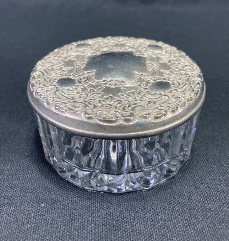 Silverplate and Glass Powder Jar: Antique silverplate and glass powder jar featuring an embossed floral-design silverplate lid with an interior mirror, paired with a fluted glass base that enhances its classic vanity appeal. Measures