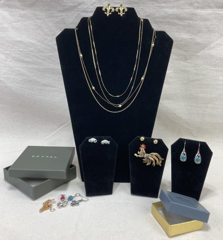 Jewelry Assortment: Assortment of mixed jewelry pieces including five earrings, two pendants, four necklace chains, one standout brooch featuring a charming rooster motif in gold tone elements, along with various loose c