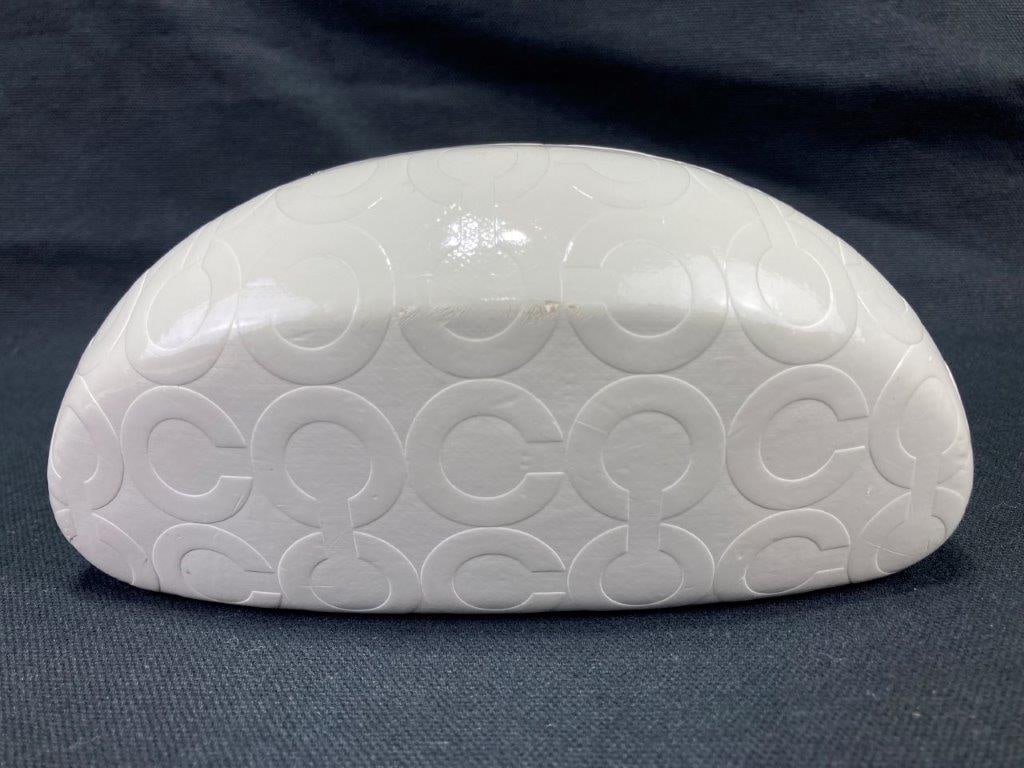 Coach White Leather Sunglasses Case: White leather Coach hard sunglasses case featuring the iconic embossed C pattern throughout, fitted with a chocolate-brown interior stamped COACH EST. 1941 in silver. In good condition with light wear