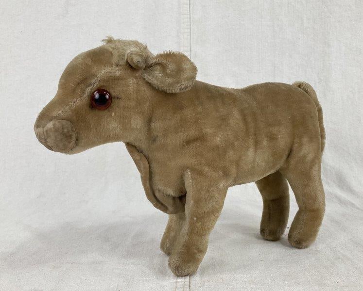 Vintage Mohair Cow: Charming tan mohair cow with velvet nose, dewlap, and tail, accented with red glass eyes and attributed to Steiff. Lovely aged patina throughout. Measures approximately 7 3/4" H x 3 3/8" W x 12 1/4" D