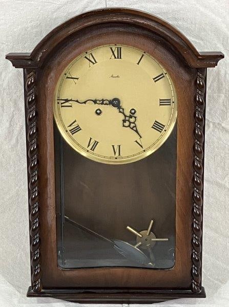 Mauthe Wall Clock: German-made Mauthe mechanical wall clock, produced by a company founded in the late 19th century. It measures approximately 19 3/4" H x 13" W x 5 7/8" D. Good condition with minimal wear.