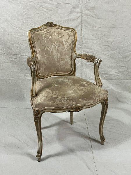 French Rococo Armchair: Elegant Rococo armchair featuring cherub and dove motif upholstery in soft cream tones, complemented by gilt accents, a white painted wood finish, and ornate carved details for classic French appeal.