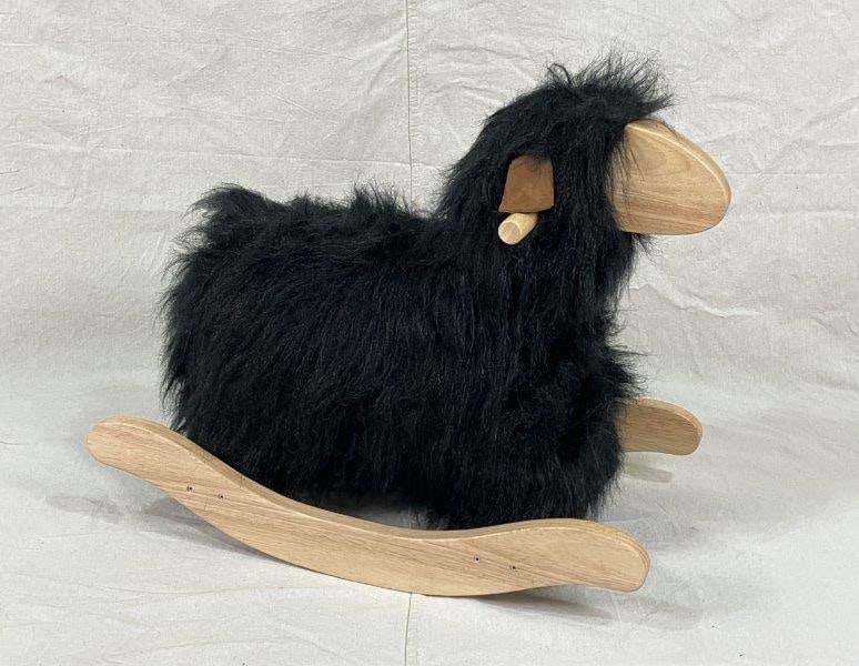 Faux Fur Rocking Sheep: A whimsical rocking sheep toy covered in soft faux fur, offering charming decor or playful utility. Measures approximately 20" H x 13 1/2" W x 25" D. In excellent condition.