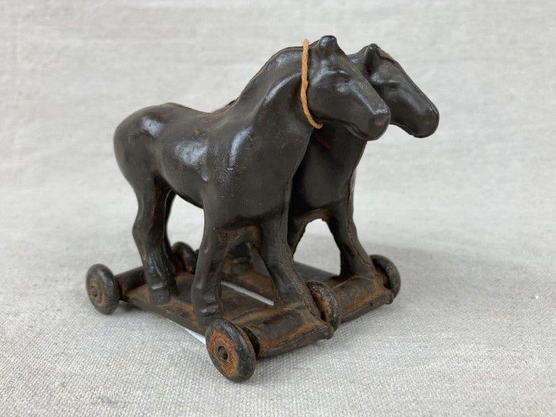 Auburn Rubber Toy Horse Team: Pull toy featuring two horses, each on their own rectangular base connected by a metal wheel axle, stamped Aub-Rubr Auburn Ind Made in USA, aged patina. Measures approximately 3 3/8'' H x 3'' W x 3 7/