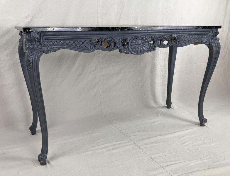 Continental Marble Top Console Table: A refined Continental console table featuring an elegant marble top set above a decorative carved wooden frame with cabriole legs. Measures approximately 29 3/8" H x 51 1/8" W x 20" D. In good conditi