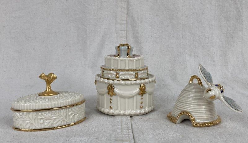 Lenox Trinket Boxes and Beehive Figure: Lovely ivory bone china pieces by Lenox with 24k gold trim. Includes an April birthstone oval trinket box from the Lenox China Treasures Collection with a floral motif handle, a birthday cake trinket