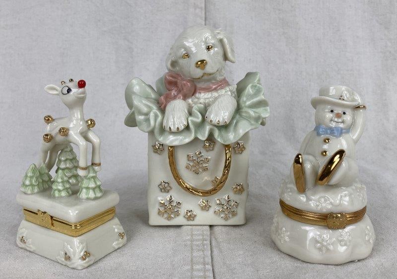 Lenox Christmas Trinket Boxes: Charming ivory bone china pieces with painted details and 24k gold accents by Lenox. Includes a Skating Adventure Snowman trinket box with a gold-plated ice skate charm, a Rudolph the Red-Nosed Reinde