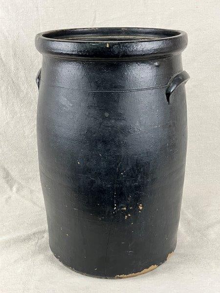 Antique Stoneware Crock: This substantial antique stoneware crock features a wide-bodied form with a narrowed neck and molded applied handles, all finished in a rich dark glaze. Measures approximately 16 1/8" H x 10" in diame