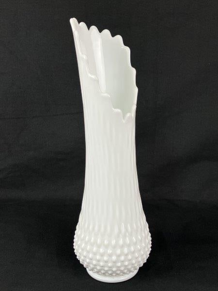 Fenton Hobnail Milk Glass Swung Vase: A classic Fenton hobnail milk glass swung vase featuring an elegant elongated form and textured surface. Measures approximately 15" H x 4" in diameter. In good condition.