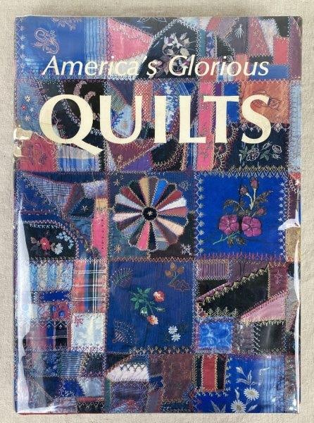America's Glorious Quilts Book: Hardcover volume showcasing 272 American quilts spanning various historical periods, authored by Dennis Duke and Deborah Harding. Warm aged patina to the cover wrap. Measures approximately 15'' H x 11