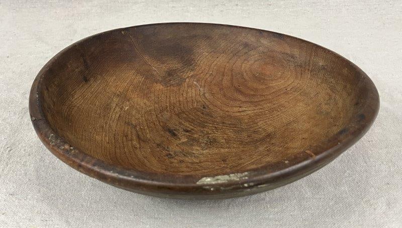 Turned Country Wood Bowl: A warmly aged turned wood bowl displaying a rich, worn patina and classic country form. Measures approximately 2 1/2" H x 9 1/2" in diameter. In good condition.