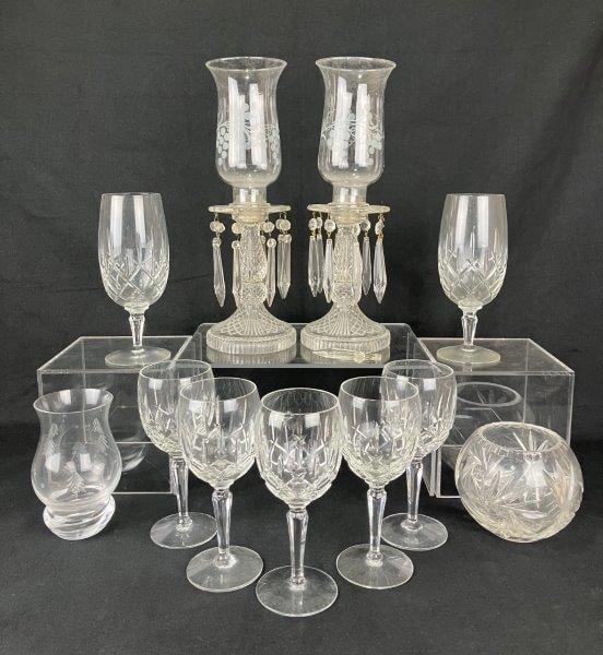 Glass Assortment Featuring Luster Candlesticks: A diverse glass assortment including eye-catching luster candlesticks with dangling crystals, hurricane shades decorated in grape-and-vine motifs, along with various goblets, wine glasses, and additio