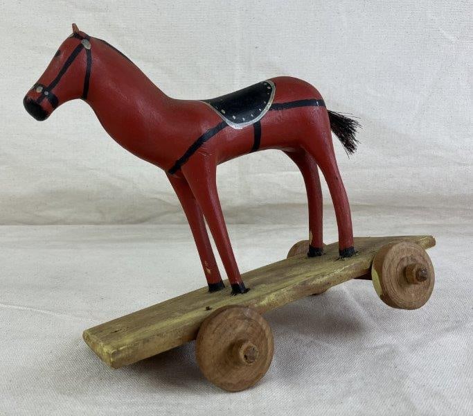 Polychromed Folk Art Horse Pull Toy: Charming folk art pull toy featuring a red and black painted horse pulling a cart with warm yellow patina, all displaying delightful early handcrafted character. The horse measures approximately 8 1/2