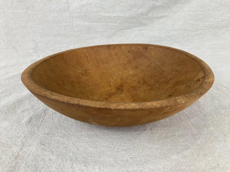 Wood Dough Bowl: Expertly turned wooden bowl displaying rich natural honey tones and an appealing aged patina. Smooth form with subtle grain variation characteristic of hand craftsmanship. Measures approximately 2 3/4