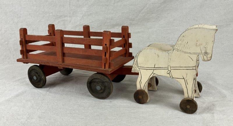 Antique Wooden Horse-Drawn Wagon Pull Toy: Charming folk art pull toy featuring a painted wooden horse and wagon, displaying early handcrafted construction and delightful primitive character. Measures approximately 6 1/2" H x 16 5/8" W x 4 1/4